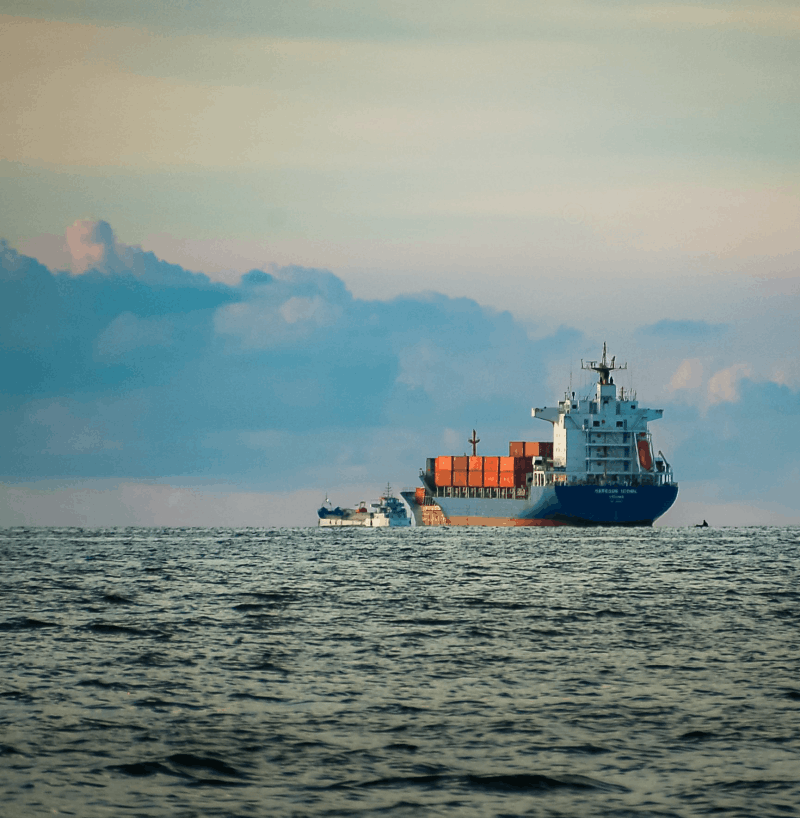Container ship carrying cargo across open water, representing the global maritime industry and the need for emissions-reduction and carbon capture technologies that help vessels lower their environmental impact and support cleaner shipping operations.
