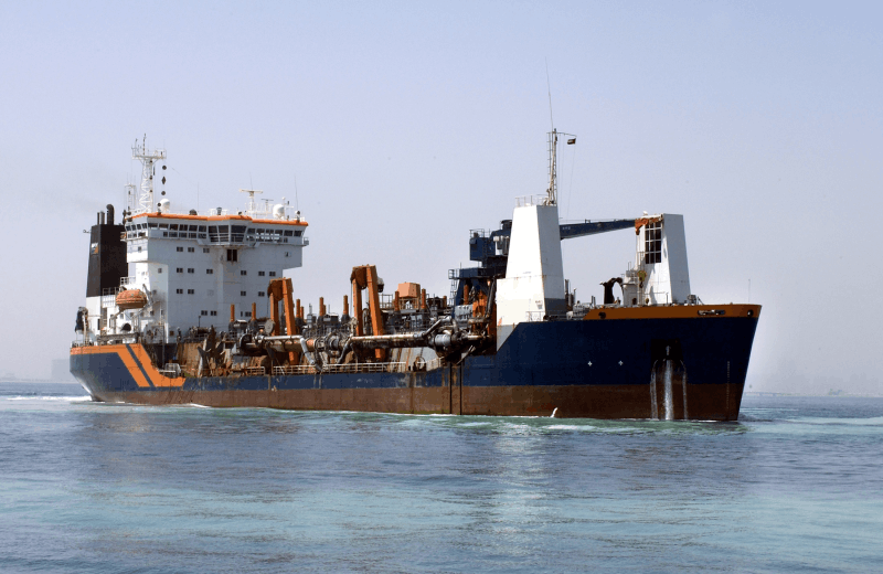 Large industrial vessel underway with extensive deck piping and heavy equipment, illustrating the maritime sector’s need for emissions-reduction technologies that help commercial ships reduce harmful exhaust and operate more sustainably.